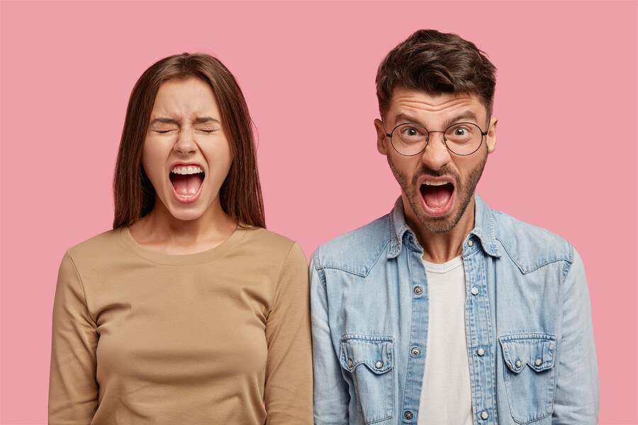 furious-young-couple-posing-against-pink-wall_0af3a.jpg