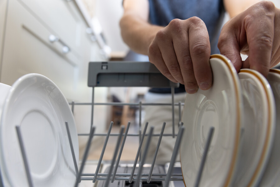 man-front-open-dishwasher-takes-out-clean-dishes-after-washing_13d84.jpg