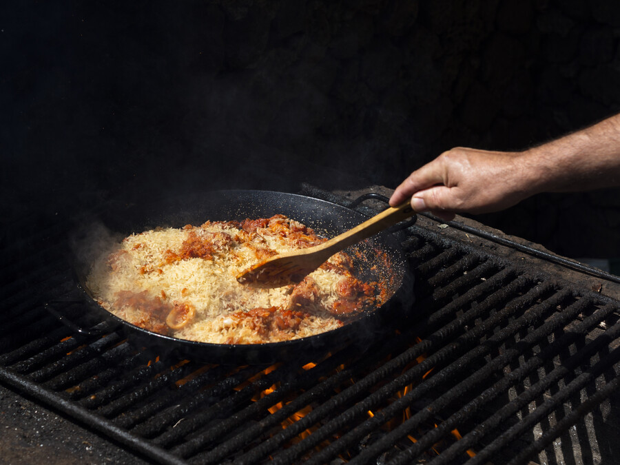 cook-mixing-rice-with-calamari-rings-vegetables-frying-pan_212e6.jpg