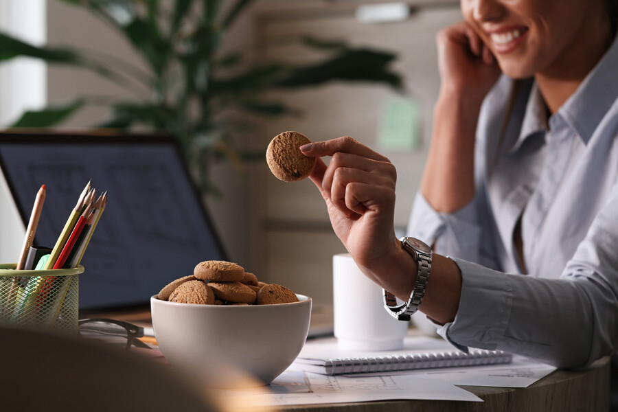 close-up-businesswoman-eating-cookies-break-her-office_865c1.jpg