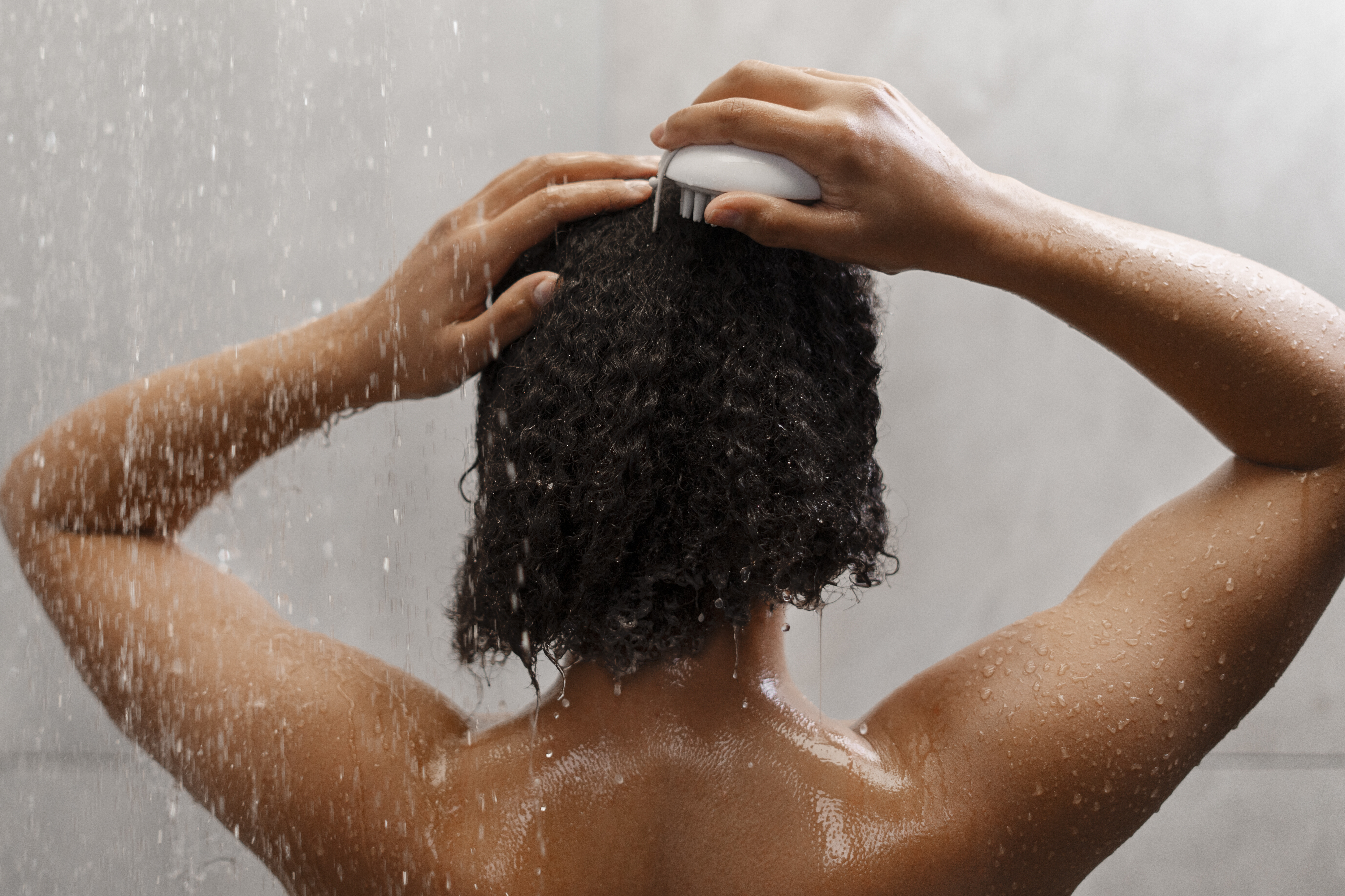 woman giving herself scalp massage cdc50