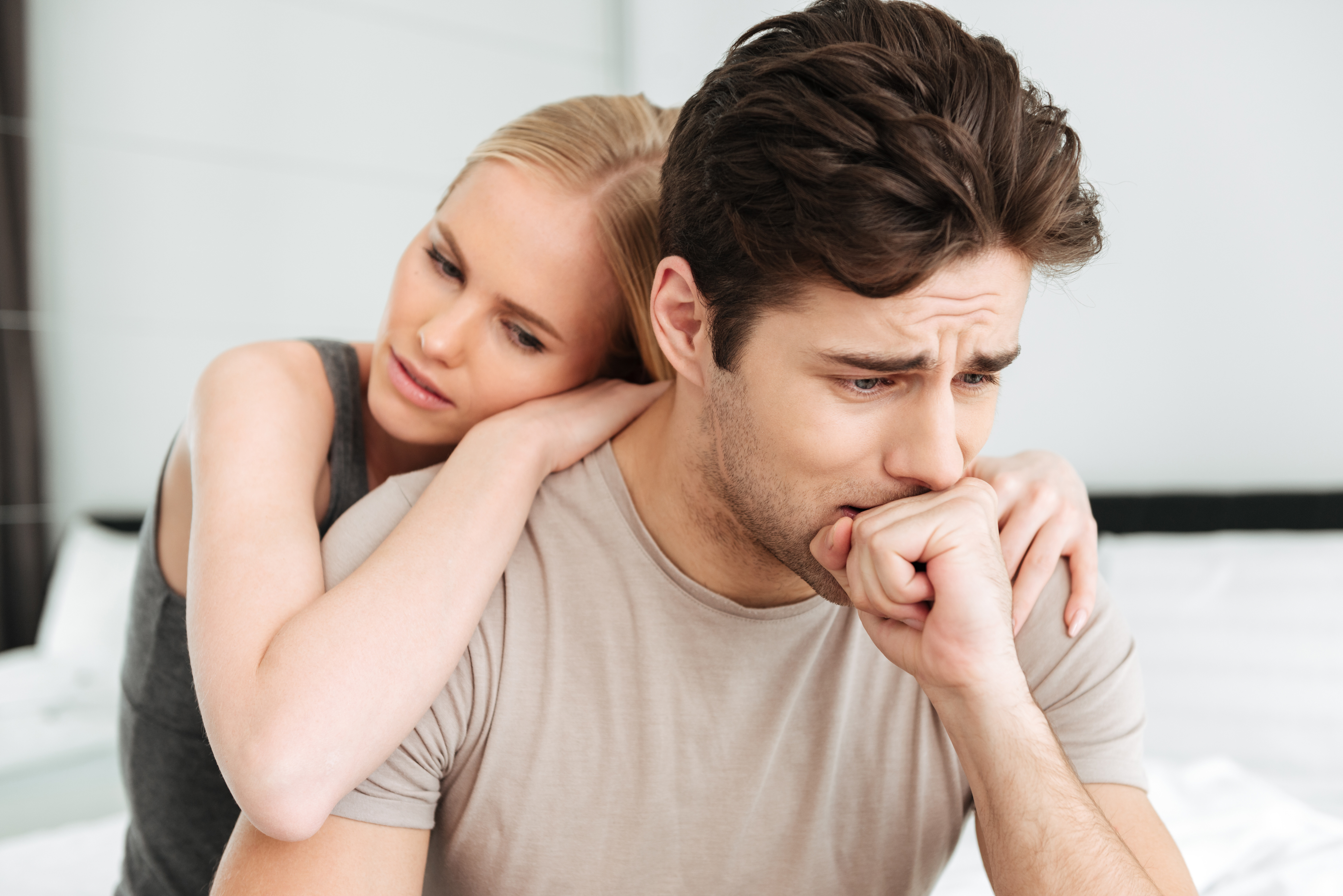 pretty woman comfort her sad man while they sitting bed 9ec4f
