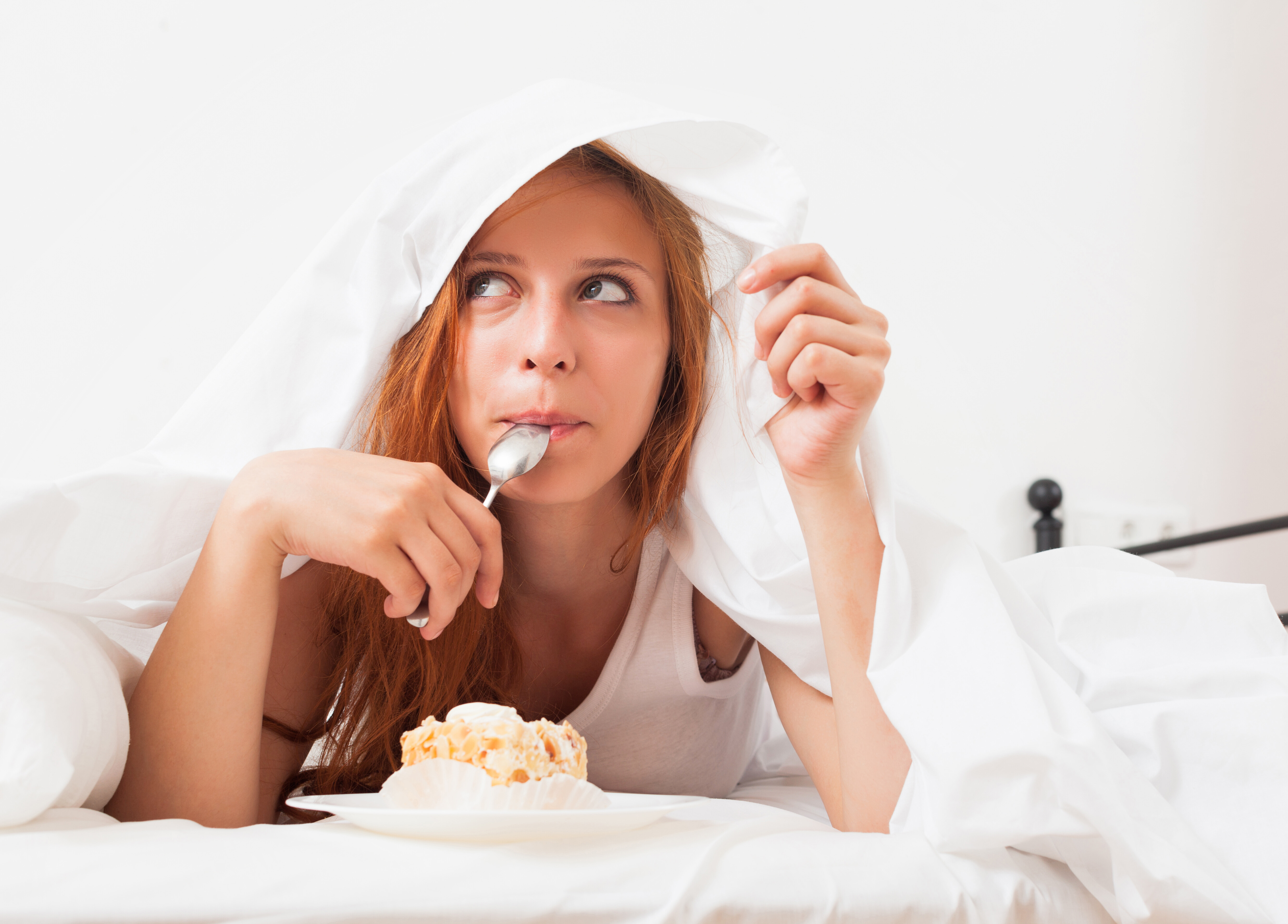 girl eating biscuit her bed 1276f