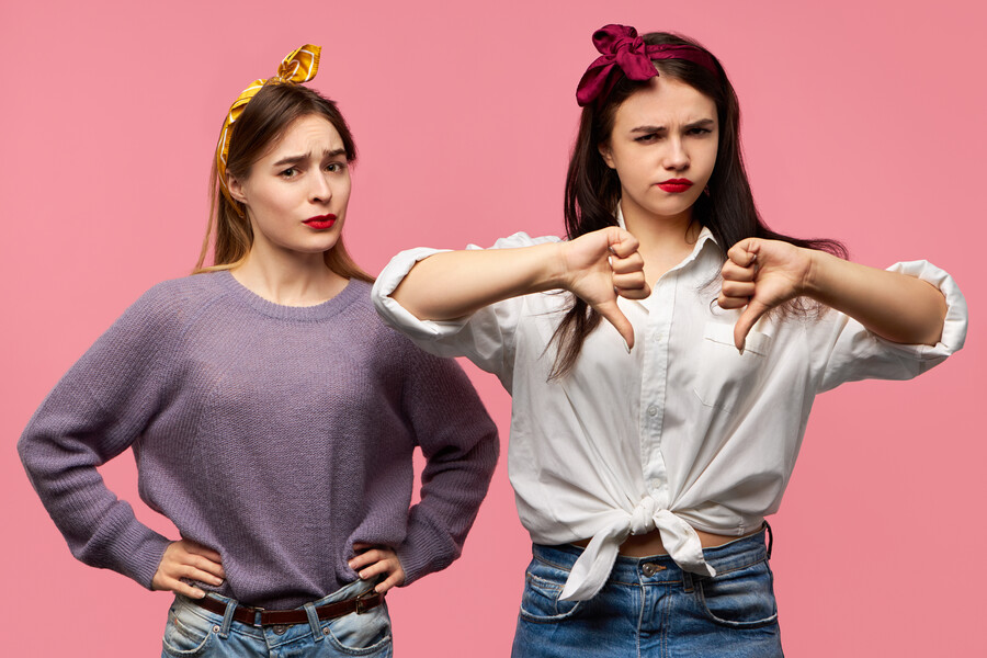 isolated-shot-two-attractive-young-woman-expressing-disapproval-dislike-being-disappointed-with-bad-quality-showing-thumbs-down-gesture-having-displeased-looks_96cd5.jpg