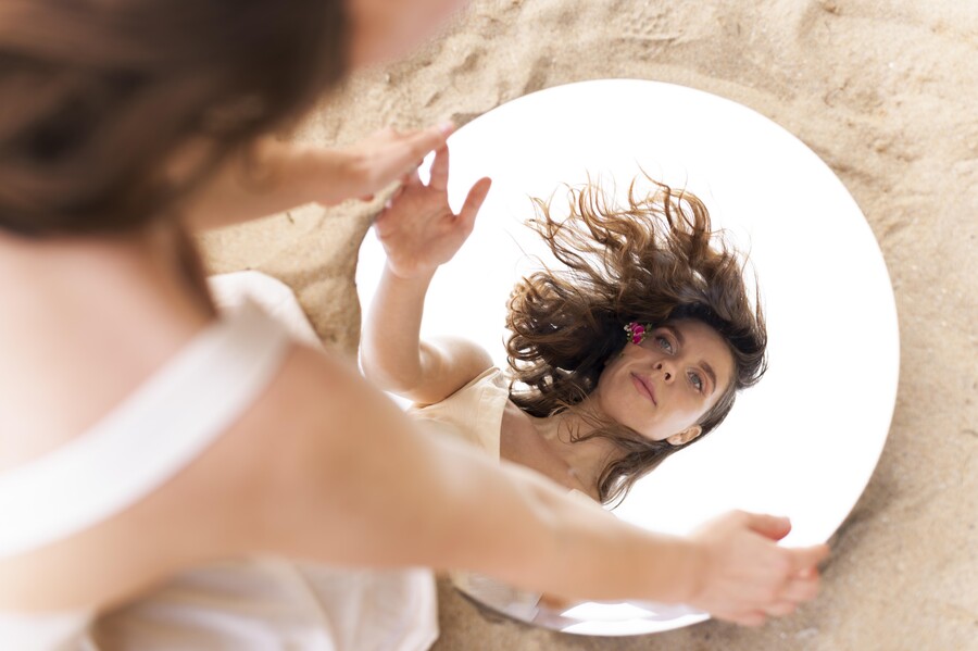 portrait-young-woman-posing-confidently-outdoors-with-round-mirror_3a8a6.jpg