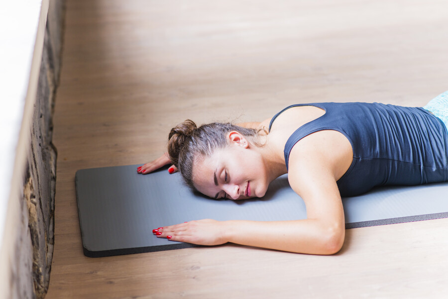 fitness-young-woman-lying-exercise-mat-wooden-background_acce0.jpg