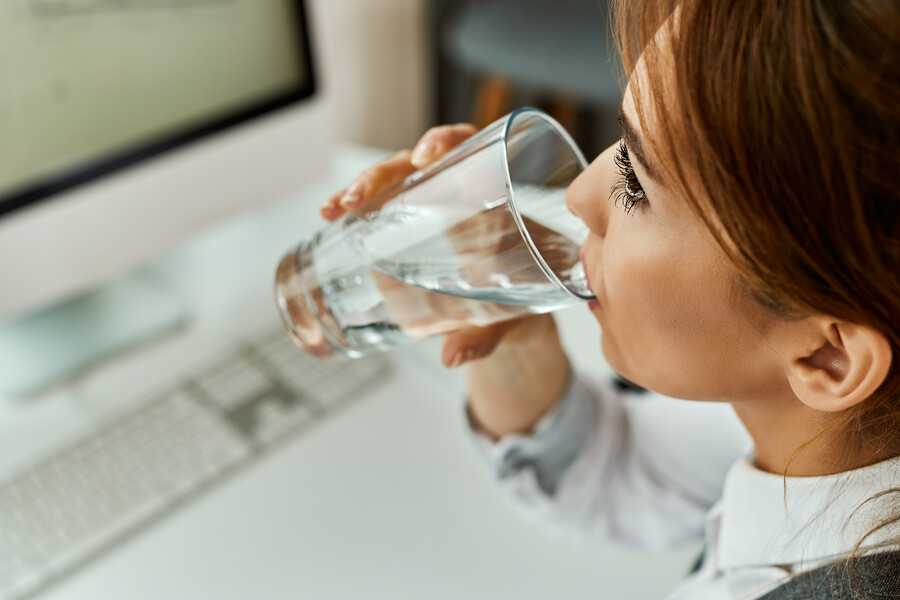 closeup-businesswoman-having-glass-water-while-working-un-office_5966f.jpg
