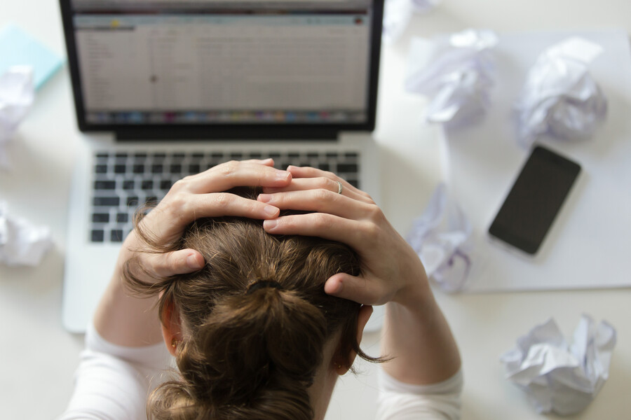 portrait-woman-grabbing-head-desk-near-laptop_c5f84.jpg
