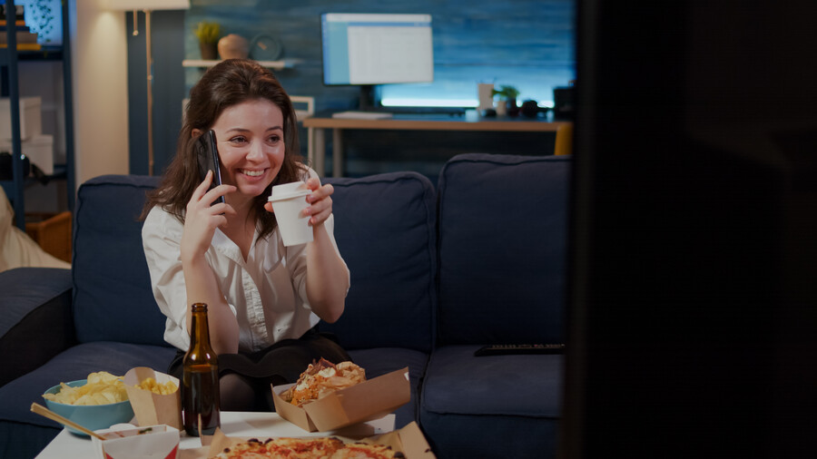 caucasian-adult-enjoying-phone-call-with-friend-living-room-while-drinking-coffee-woman-talking-smartphone-preparing-eat-fast-food-delivery-meal-home-after-work-relax_27fa8.jpg