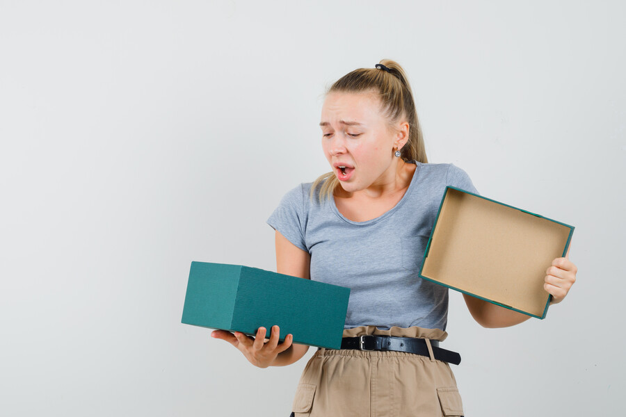 young-lady-looking-into-present-box-t-shirt-pants-looking-downcast_7b105.jpg