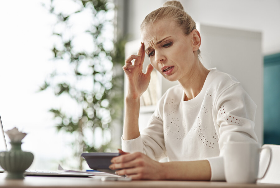worried-woman-with-calculator-home-office_10df0.jpg