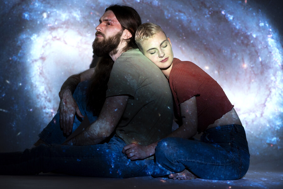 portrait-man-woman-posing-with-universe-projection-texture_36599.jpg