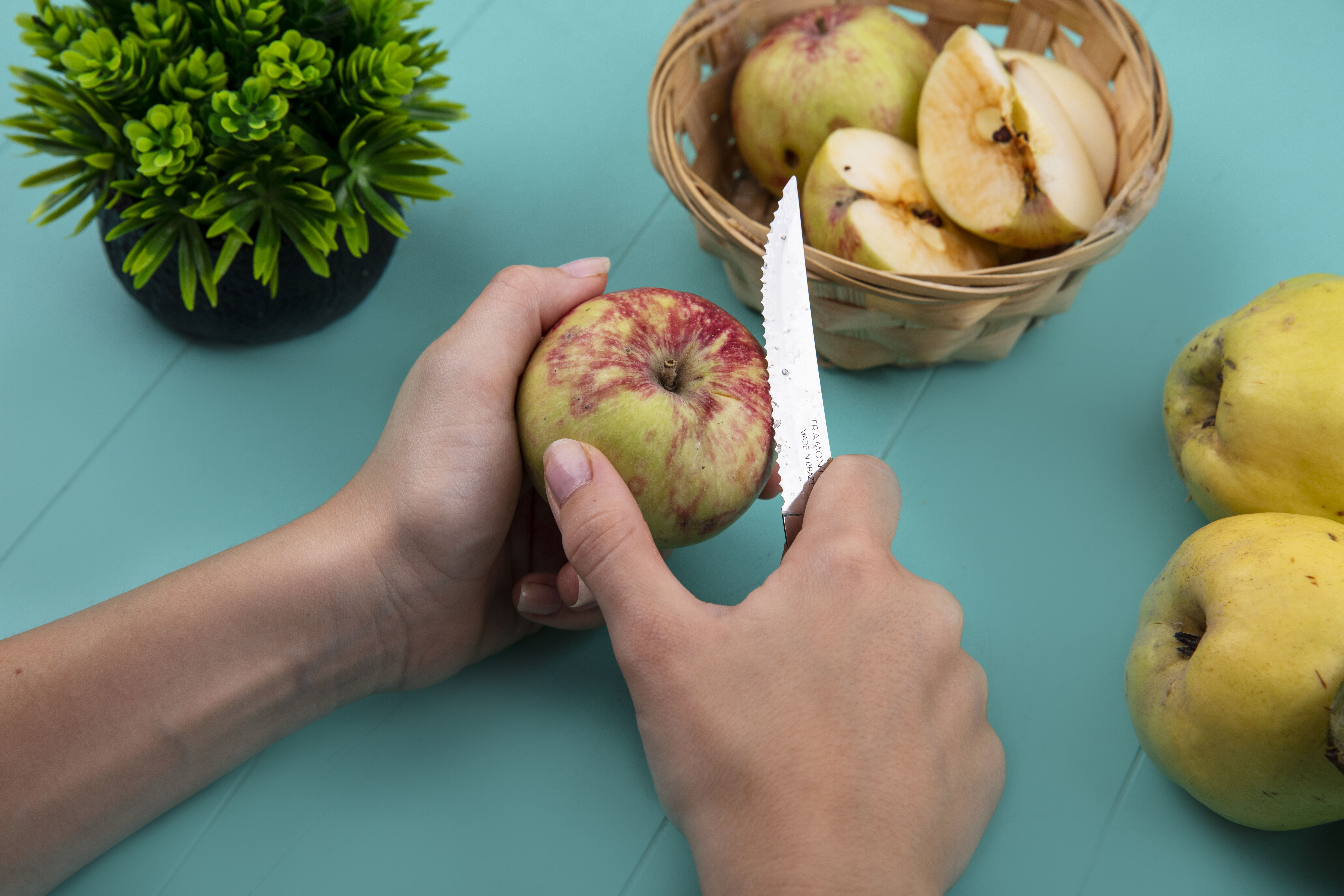 top view female hands cutting fresh apple with knife blue background e7d24