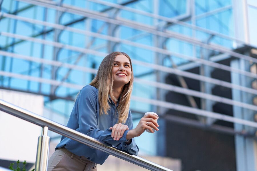 young-smiling-professional-woman-having-coffee-break-her-full-working-day-she-holds-paper-cup-outdoors-near-business-building-while-relaxing-enjoying-her-beverage_3c326.jpg
