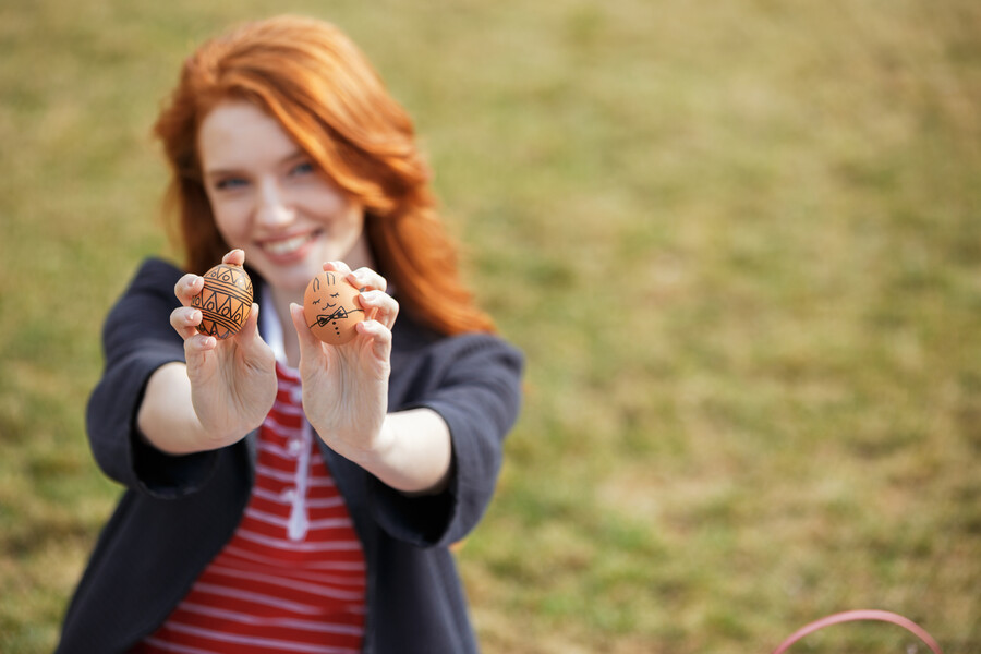 woman-with-long-ginger-hair-showing-two-painted-easter-eggs_85312.jpg