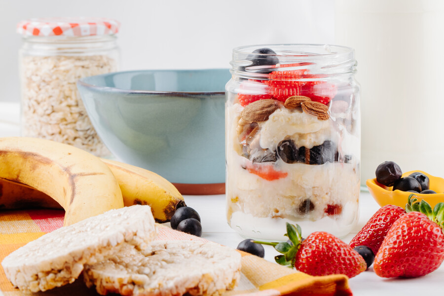 side-view-overnight-oats-with-fresh-strawberries-blueberries-nuts-glass-jar-rustic-table_bb4cb.jpg