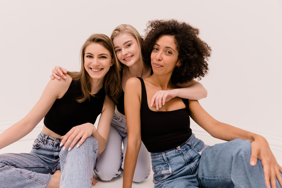 cute-young-caucasian-african-ladies-tops-jeans-look-camera-white-background-diverse-ethnicity-lifestyle_3b02e.jpg