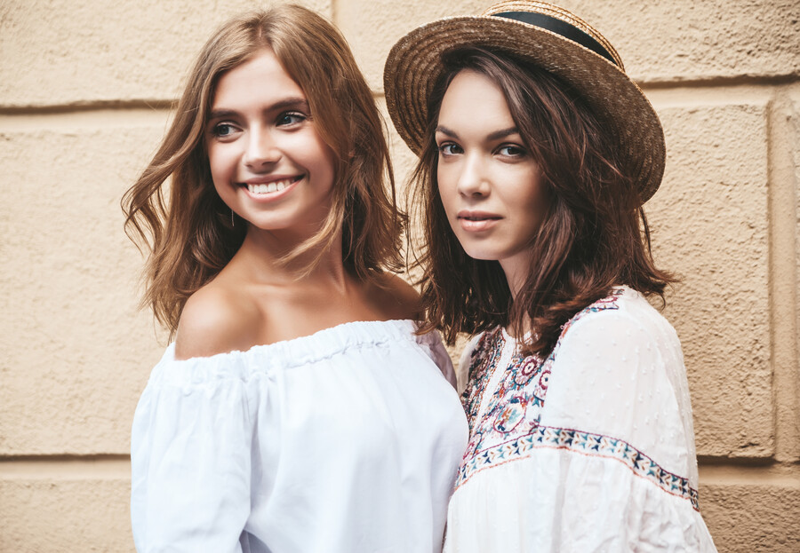 fashion-portrait-two-young-stylish-hippie-brunette-blond-women-models-summer-sunny-day-white-hipster-clothes-posing-near-yellow-wall-no-makeup_0557c.jpg