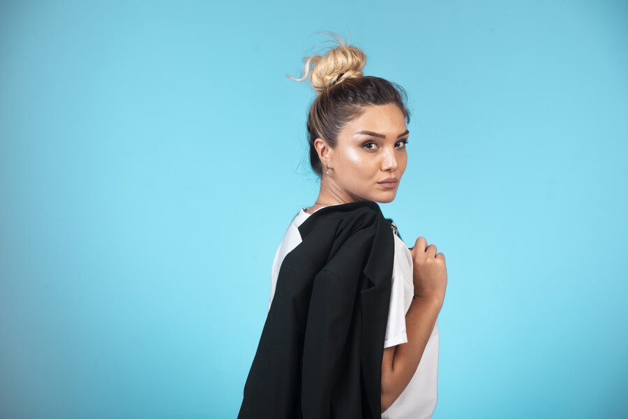 young-businesswoman-bun-holding-black-blazer_a8fed.jpg