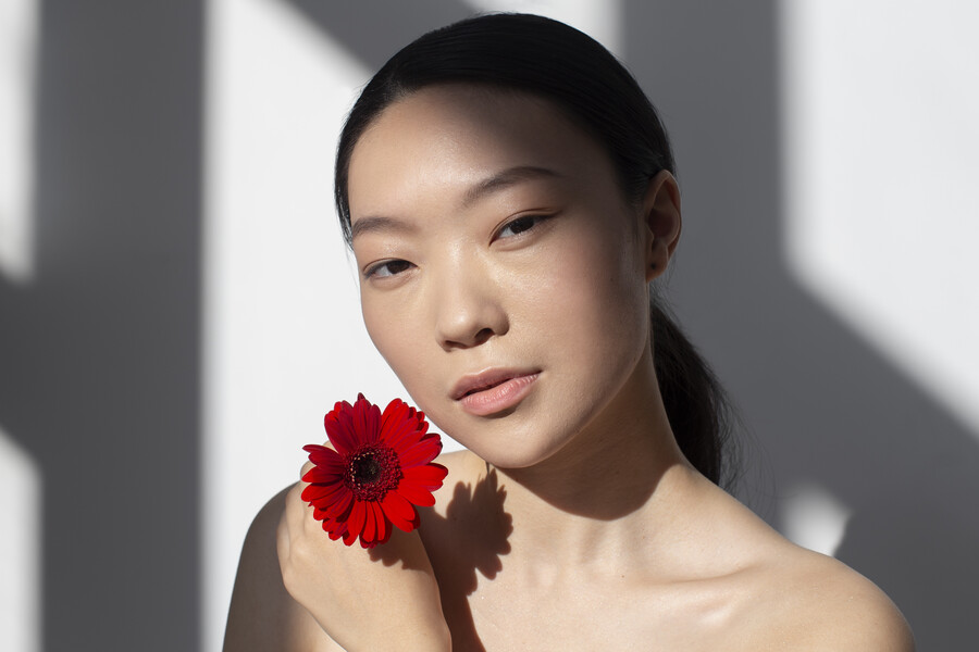 beautiful-asian-woman-posing-holding-rose-with-perfect-skin_ac7b4.jpg
