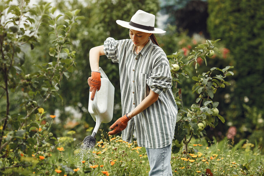 gardening-summer-woman-watering-flowers-with-watering-can-girl-wearing-hat_edf1b.jpg