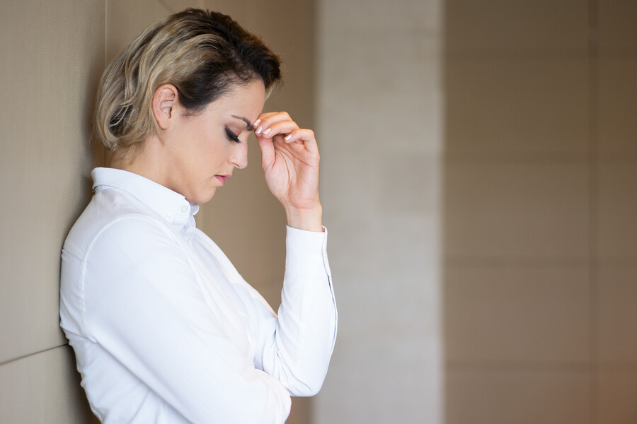 thinking-hard-businesswoman-leaning-wall_f935b.jpg