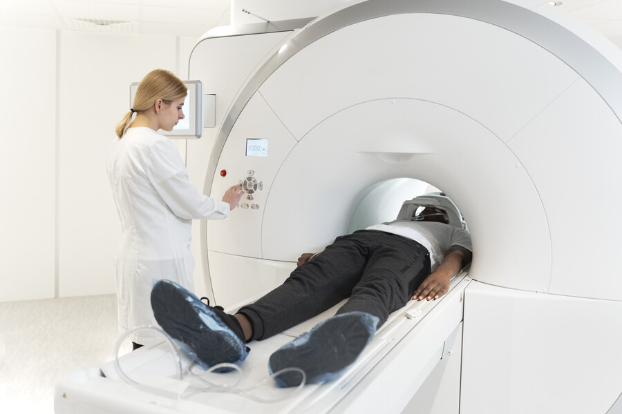 high-angle-young-doctor-pressing-ct-scan-buttons_e1313.jpg