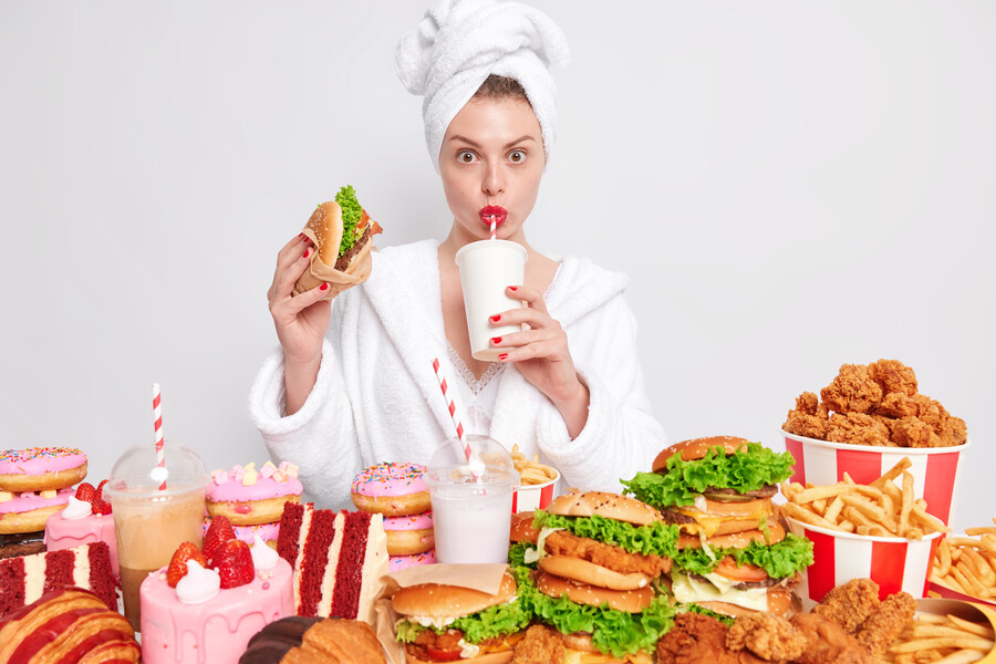unhealthy-nuttrition-concept-housewife-with-red-manicure-lips-domestic-bathrobe-towel-head-drinks-soda-eats-junk-food_73a62.jpg