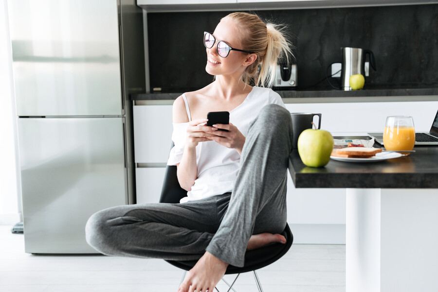 young-attractive-lady-looking-aside-while-using-smartphone_a414c.jpg