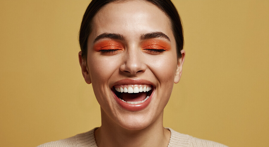 joyful-woman-with-orange-eyeshadow_53c82.jpg