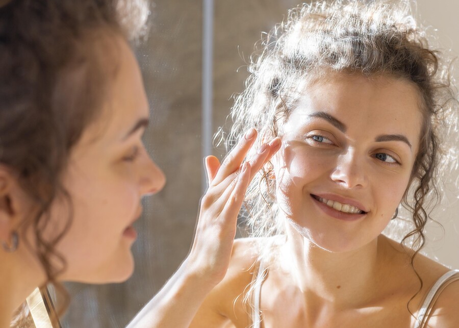 woman-looking-mirror-applying-face-cream_f0146.jpg