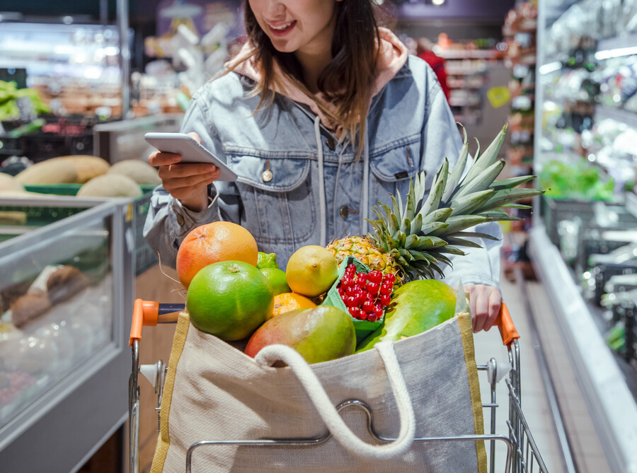 young-woman-buys-groceries-supermarket-with-phone-her-hands_71cbd.jpg