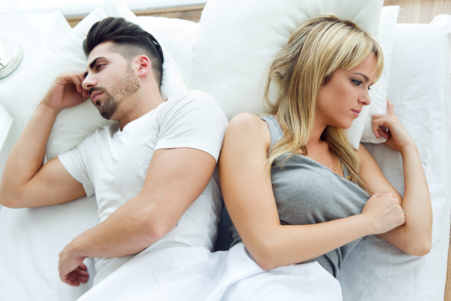 upset-couple-lying-back-back-bed_034a7.jpg