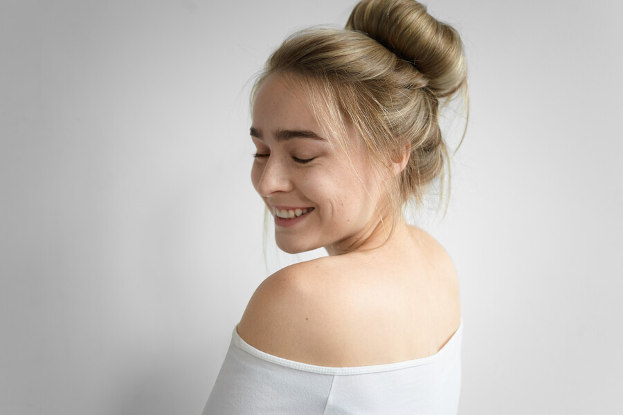 charming-girl-with-hair-bun-nude-back-posing-isolated-closing-eyes-smiling-broadly-picture-attractive-young-caucasian-woman-with-messy-hairstyle-enjoying-good-day_77fcb.jpg