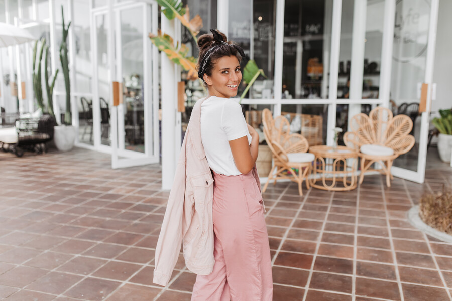 lady-pink-denim-jacket-pants-is-smiling-affably-as-she-passes-by-street-cafe_eb195.jpg