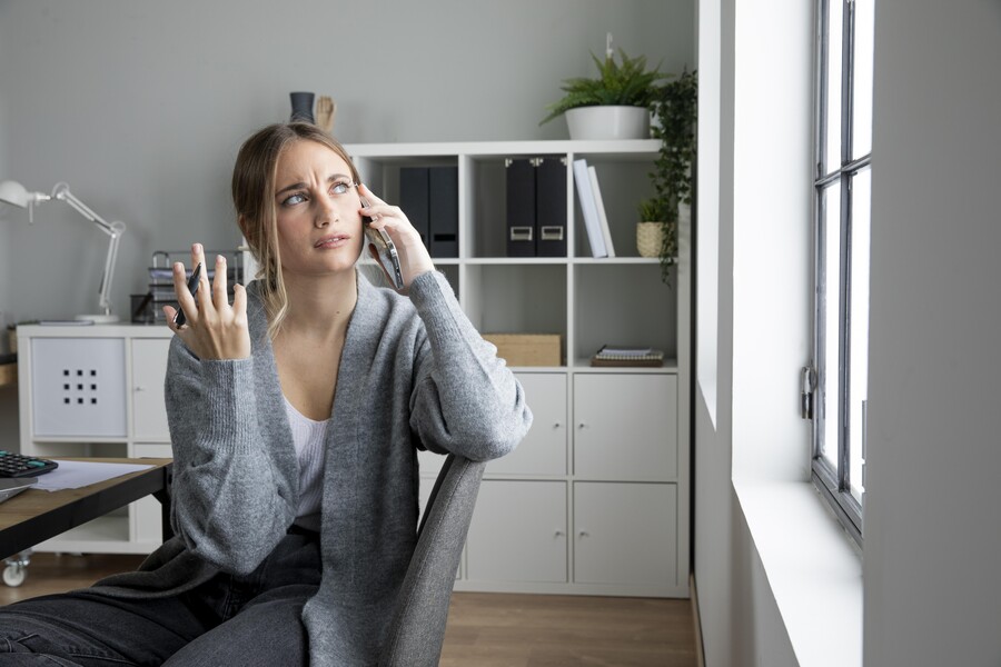 medium-shot-confused-woman-talking-phone_368e6.jpg