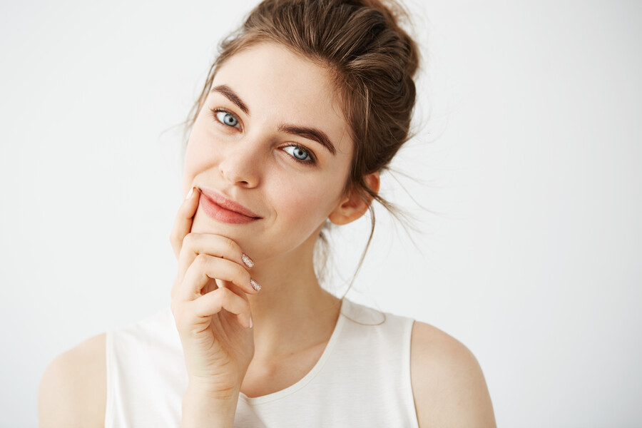 portrait-young-beautiful-tender-woman-with-bun-smiling-touching-face_c9564.jpg