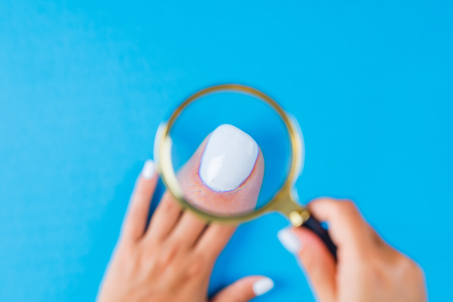 woman-holding-magnifying-glass-nail_8ec73.jpg