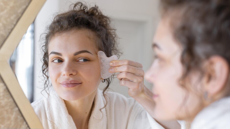 woman-looking-mirror-doing-face-massage_bbd8c.jpg