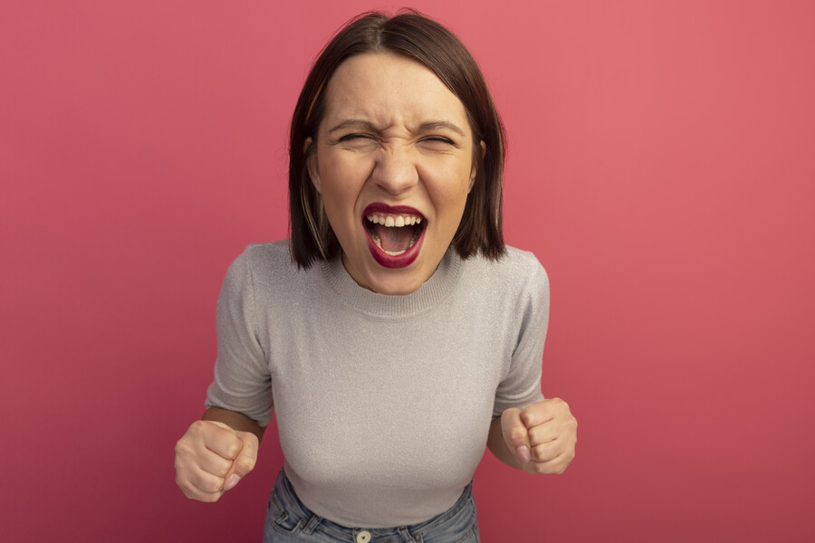 annoyed-pretty-woman-keeps-fists-screams-isolated-pink-wall_b03db.jpg