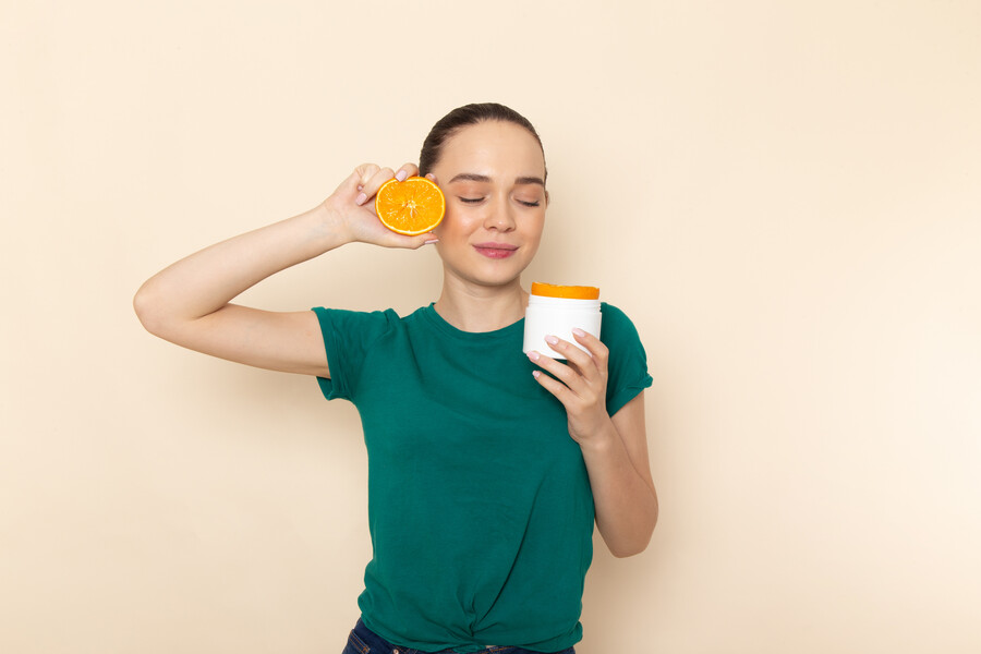 front-view-young-attractive-female-dark-green-shirt-holding-orange-can-beige_4ab9b.jpg
