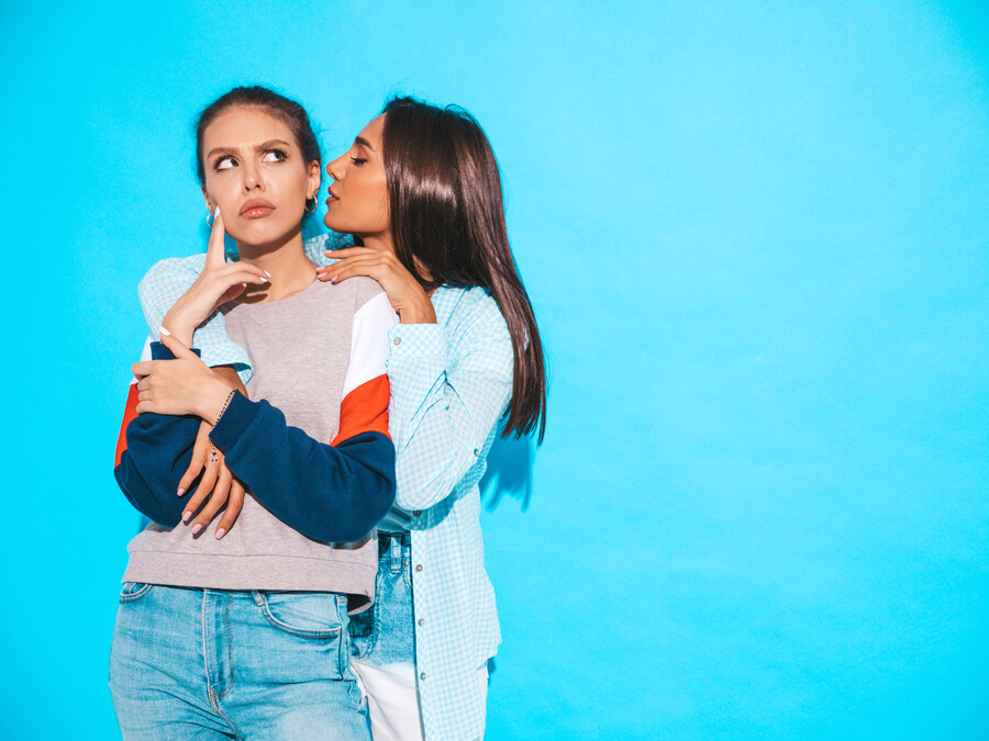 two-young-beautiful-smiling-hipster-girls-trendy-summer-casual-clothes-sexy-women-share-secrets-gossip-isolated-blue-surprised-face-emotions_70515dc2e17f8a0c.jpg