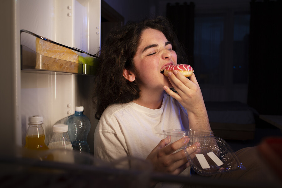 side-view-woman-eating-doughnut_17174046f4d7ffc8.jpg