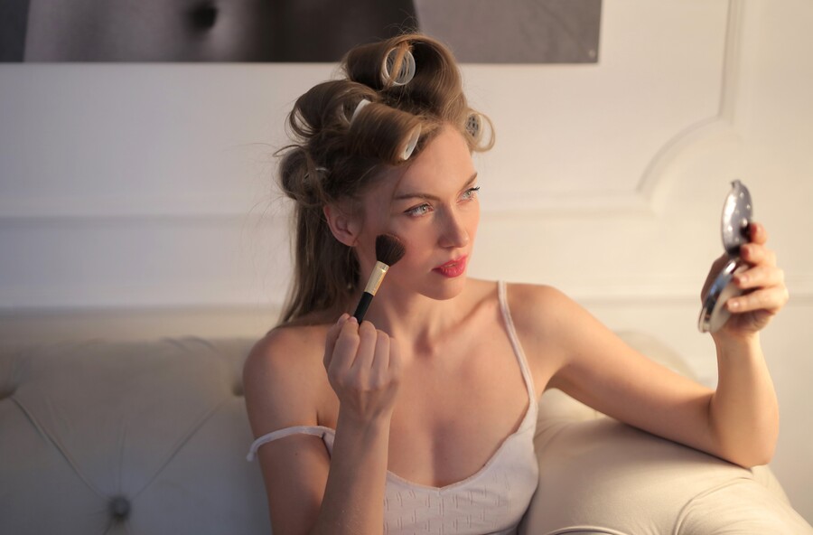 attractive-female-sitting-white-sofa-putting-her-makeup_a4bb7ff63575b374.jpg